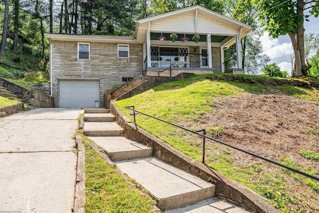 552 White Ave, Morgantown, WV 26501 - view of front of house with a garage, concrete driveway, covered porch, a front yard, and stone siding