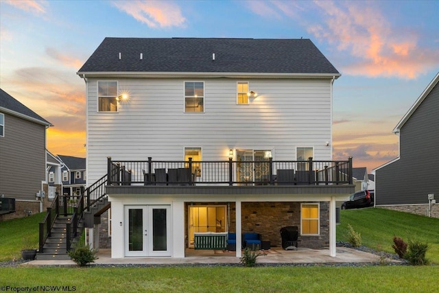 245 Falling Water Ln, Morgantown, WV 26508 - back of house at dusk with stairway, a patio area, a yard, a deck, and french doors