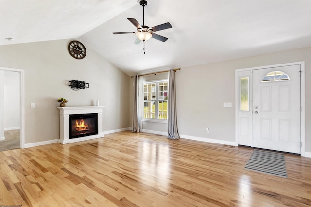 206 Angel Falls Way, Morgantown, WV 26508 - unfurnished living room featuring light wood-style floors, a ceiling fan, a glass covered fireplace, and lofted ceiling