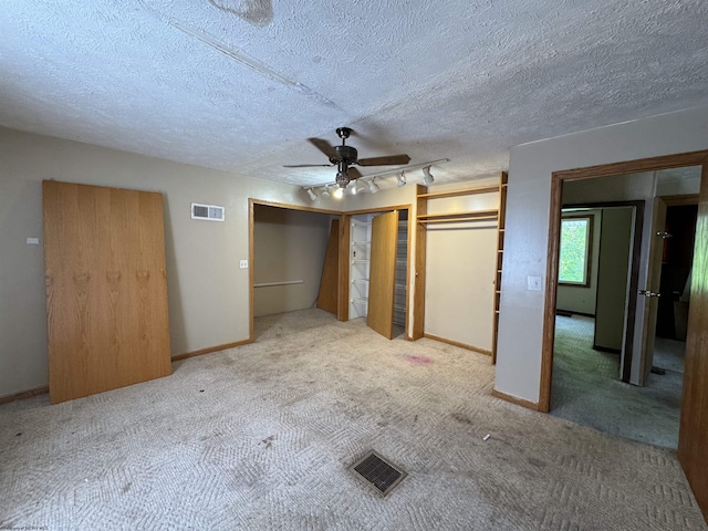 113 Buckhannon Ave, Clarksburg, WV 26301 - unfurnished bedroom featuring carpet flooring, a ceiling fan, multiple closets, and a textured ceiling
