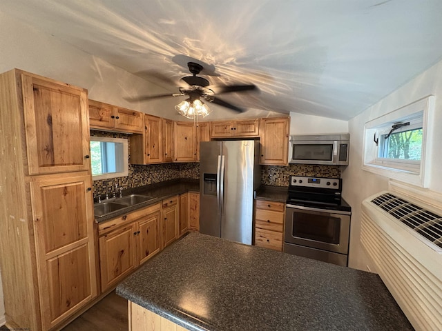1998 Lake Floyd Cir, Bristol, WV 26426 - kitchen featuring appliances with stainless steel finishes, dark countertops, vaulted ceiling, and backsplash