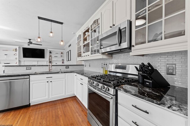 901 Suncrest Pl, Morgantown, WV 26505 - kitchen with appliances with stainless steel finishes, tasteful backsplash, dark stone counters, glass insert cabinets, and ceiling fan