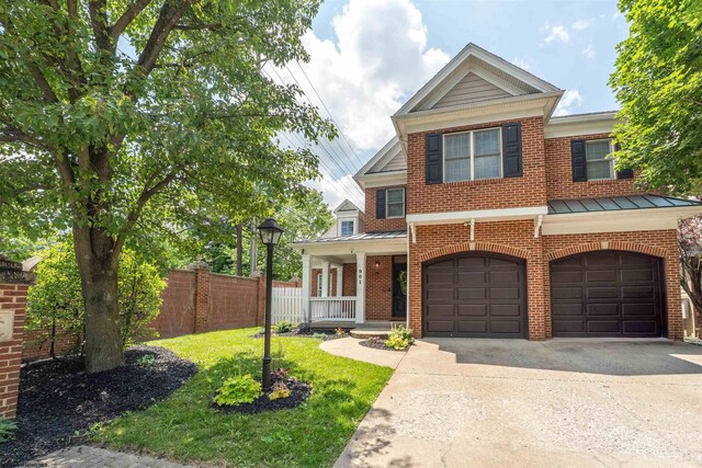 901 Suncrest Pl, Morgantown, WV 26505 - view of front of house featuring a standing seam roof, brick siding, concrete driveway, a porch, and a metal roof