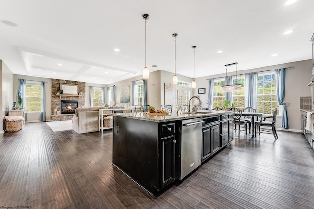 101 S Channel Path, Morgantown, WV 26508 - kitchen featuring dishwasher, dark cabinets, a stone fireplace, light stone countertops, and a center island with sink