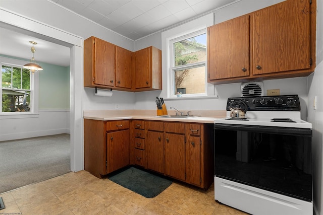 913 Ridgeway Ave, Morgantown, WV 26505 - kitchen featuring electric range oven, brown cabinets, light countertops, and plenty of natural light