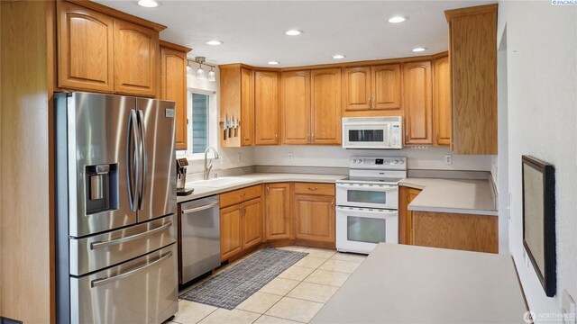 863 S Meadowlark Ln, Othello, WA 99344 - kitchen featuring stainless steel appliances, a sink, light tile patterned floors, light countertops, and recessed lighting
