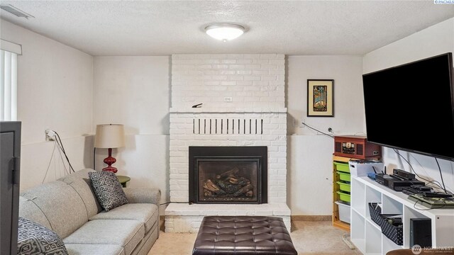863 S Meadowlark Ln, Othello, WA 99344 - carpeted living area with a textured ceiling and a fireplace