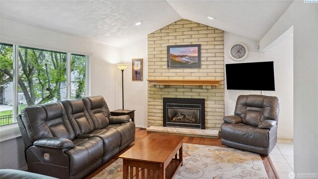 863 S Meadowlark Ln, Othello, WA 99344 - living room featuring lofted ceiling, a fireplace, and a textured ceiling