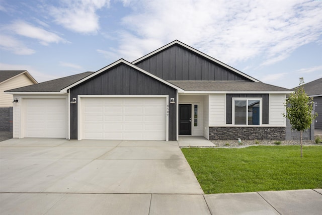 8509 Ashen Dr, Pasco, WA 99301 - craftsman inspired home featuring an attached garage, concrete driveway, a shingled roof, a front yard, and stone siding