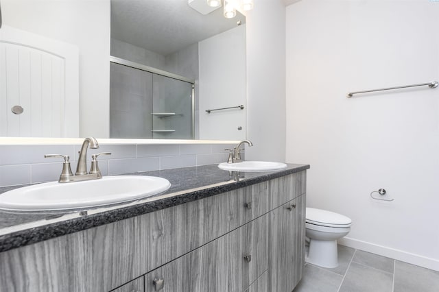 8509 Ashen Dr, Pasco, WA 99301 - full bathroom featuring double vanity, an enclosed shower, tile patterned flooring, and tasteful backsplash