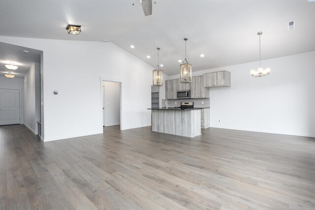8509 Ashen Dr, Pasco, WA 99301 - kitchen with appliances with stainless steel finishes, open floor plan, dark countertops, a chandelier, and recessed lighting