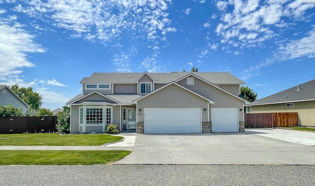 craftsman house with a garage and a front lawn