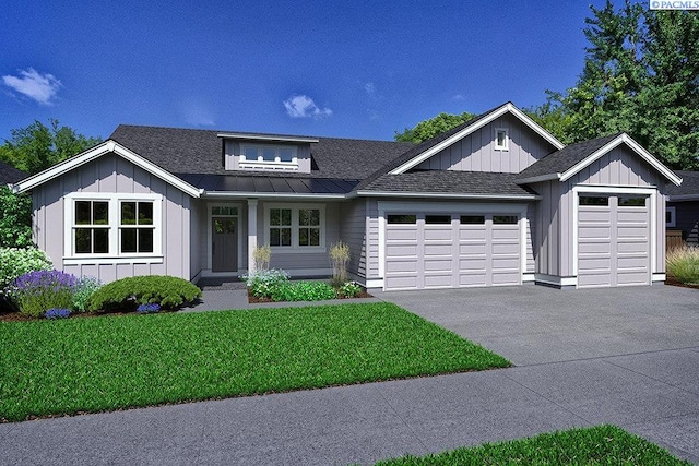 view of front of house featuring a garage and a front lawn