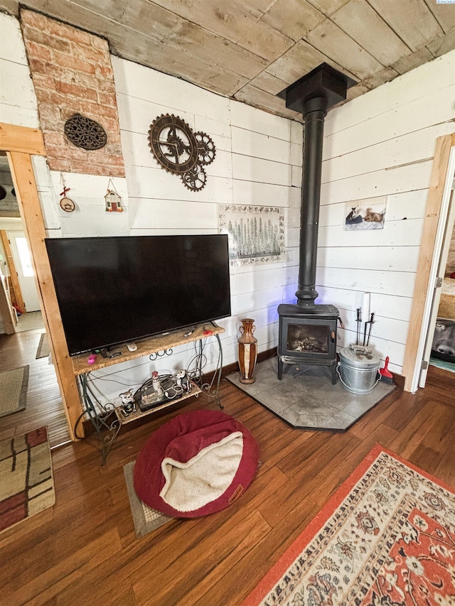 307 G St, Endicott, WA 99125 - living room featuring wood finished floors, a wood stove, and wooden walls
