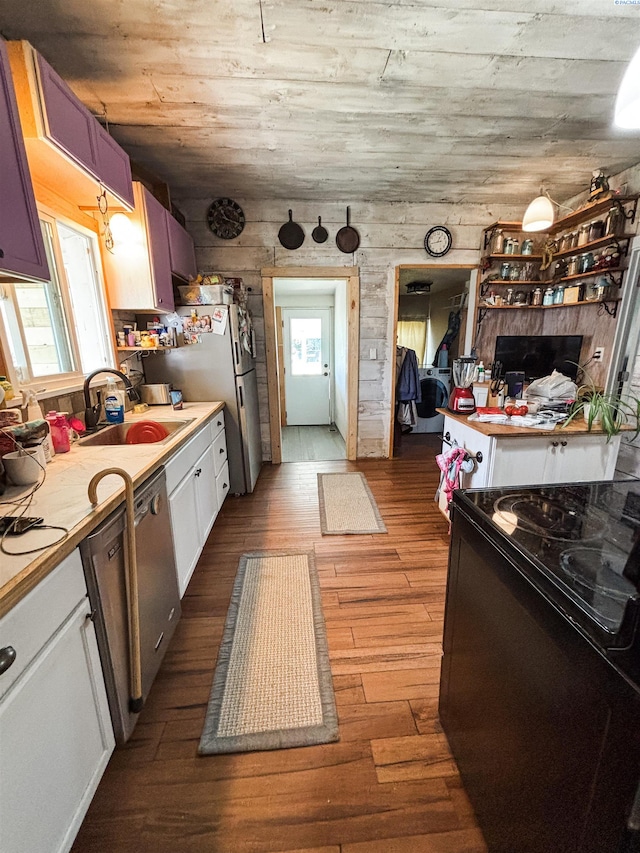 307 G St, Endicott, WA 99125 - kitchen featuring black electric range, healthy amount of natural light, dark wood finished floors, and white cabinetry