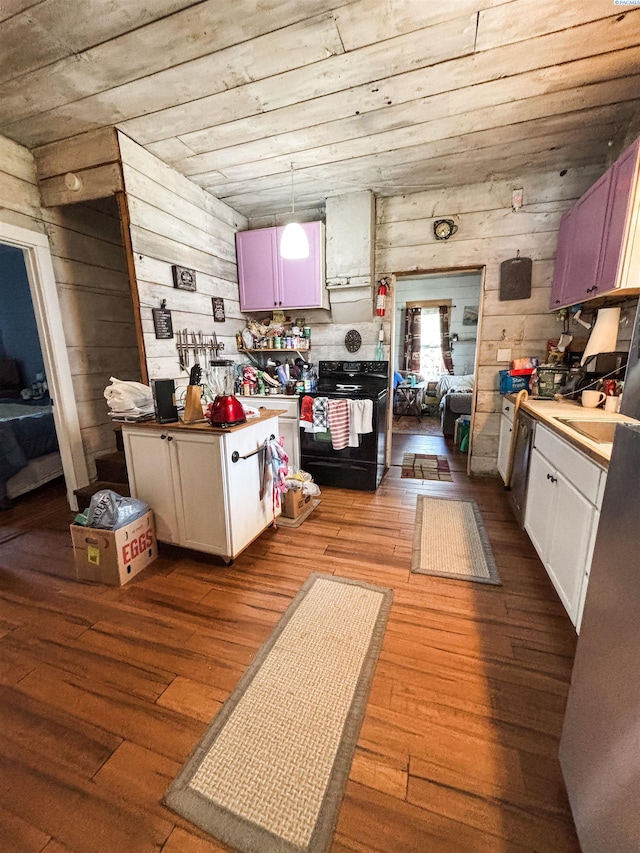 307 G St, Endicott, WA 99125 - kitchen with black / electric stove, wood-type flooring, and wooden walls