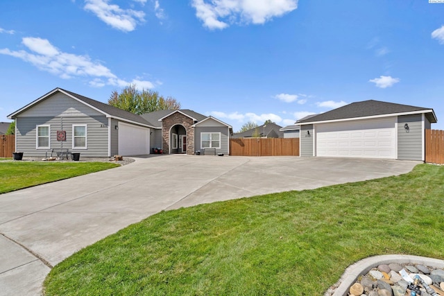 ranch-style house with fence, a front lawn, and a detached garage