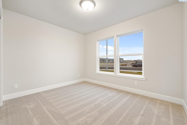 empty room with carpet and a textured ceiling