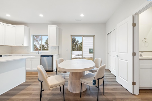 dining room with recessed lighting, visible vents, plenty of natural light, and light wood-style floors