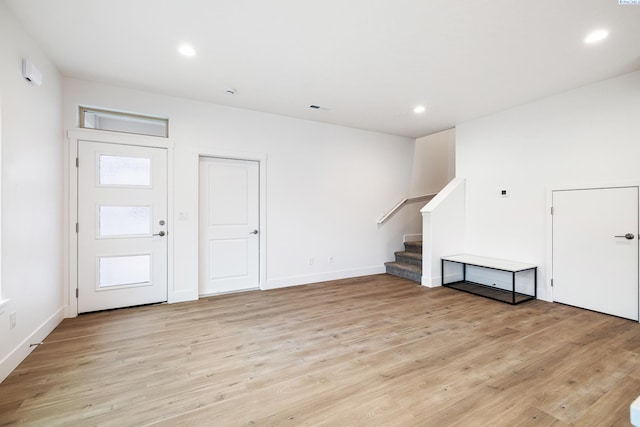 interior space with recessed lighting, baseboards, light wood-type flooring, and stairs
