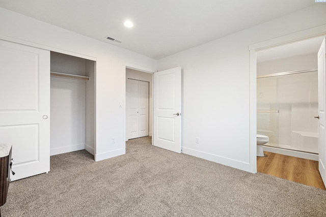 unfurnished bedroom with visible vents, carpet, baseboards, and a closet