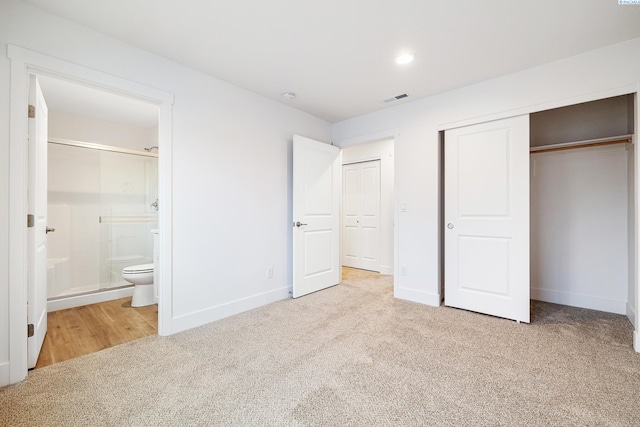 unfurnished bedroom featuring baseboards, visible vents, carpet, and a closet