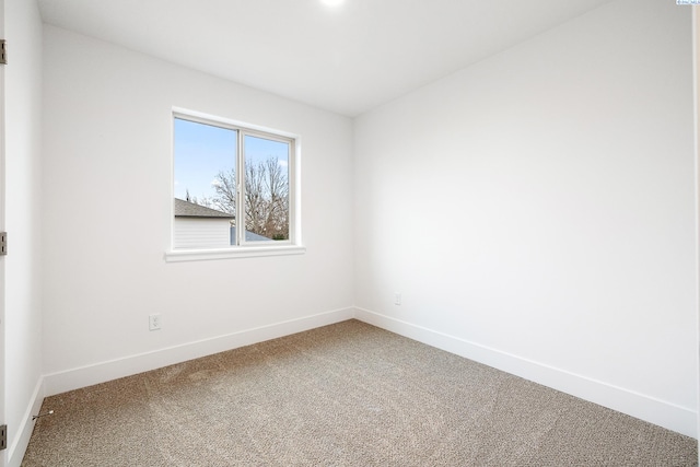 empty room with carpet floors and baseboards