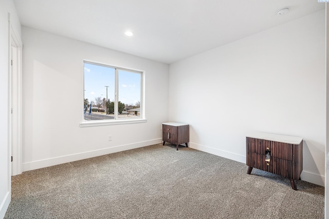 spare room featuring carpet floors, recessed lighting, and baseboards