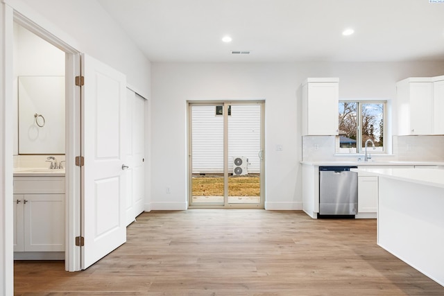 kitchen with white cabinets, dishwasher, light countertops, recessed lighting, and visible vents