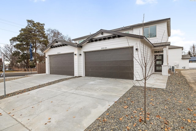 view of front of house featuring concrete driveway and an attached garage