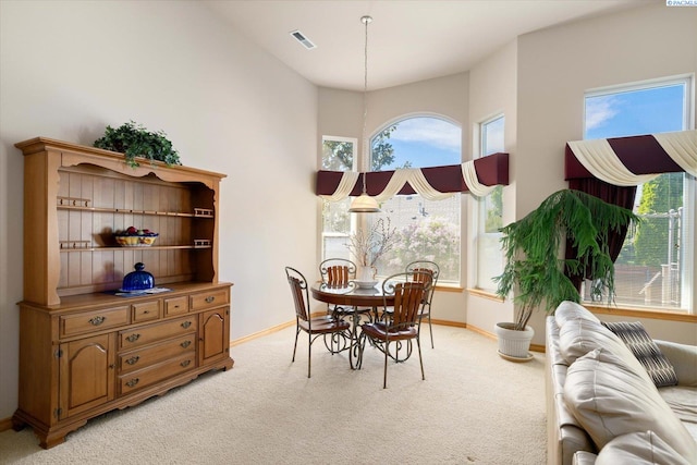 3610 S Johnson St, Kennewick, WA 99337 - dining room featuring light colored carpet, baseboards, and a towering ceiling