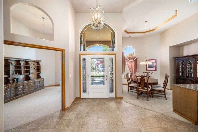 3610 S Johnson St, Kennewick, WA 99337 - carpeted entryway with a chandelier, a towering ceiling, and baseboards