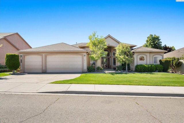 3610 S Johnson St, Kennewick, WA 99337 - single story home with an attached garage, concrete driveway, a front yard, and stucco siding