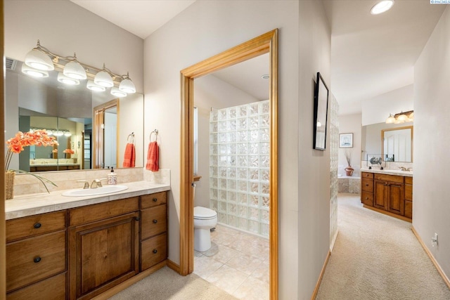 3610 S Johnson St, Kennewick, WA 99337 - full bathroom featuring two vanities, toilet, and baseboards