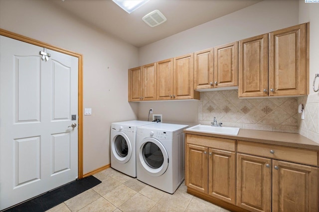 3610 S Johnson St, Kennewick, WA 99337 - laundry area featuring washing machine and clothes dryer, cabinet space, and light tile patterned floors