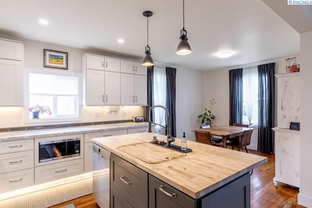 501 W California St, Garfield, WA 99130 - kitchen featuring stainless steel appliances, butcher block counters, healthy amount of natural light, wood finished floors, and recessed lighting
