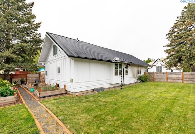 501 W California St, Garfield, WA 99130 - back of property featuring board and batten siding, a garden, and metal roof