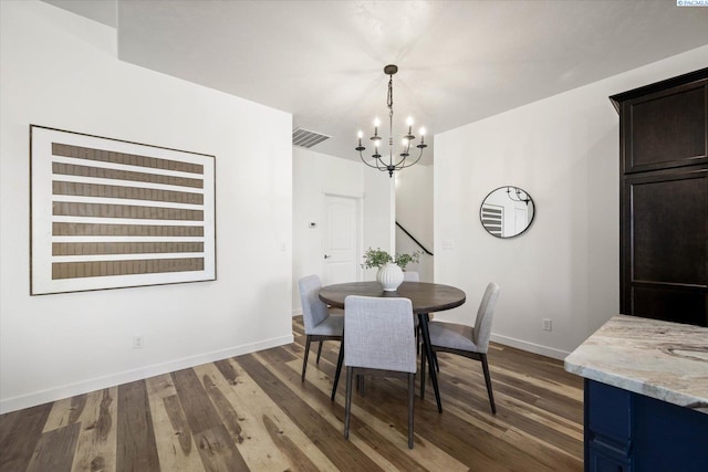 882 Pikes Peak Dr, West Richland, WA 99353 - dining room with a chandelier, baseboards, and dark wood finished floors