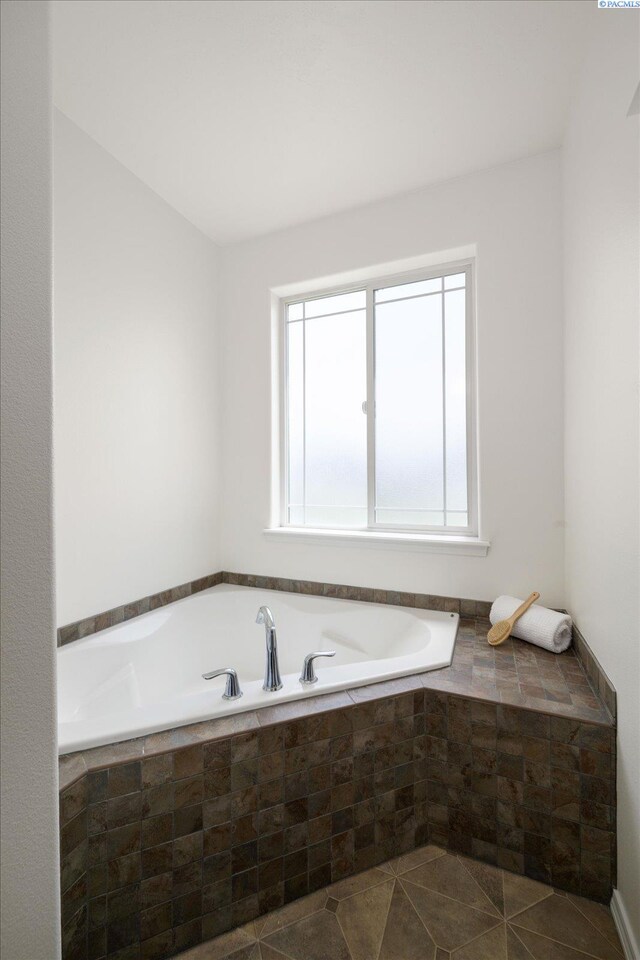 882 Pikes Peak Dr, West Richland, WA 99353 - bathroom featuring plenty of natural light, a garden tub, and tile patterned floors