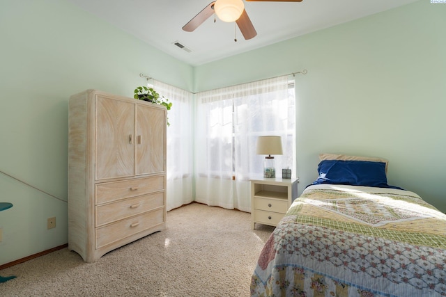 bedroom with baseboards, visible vents, and a ceiling fan