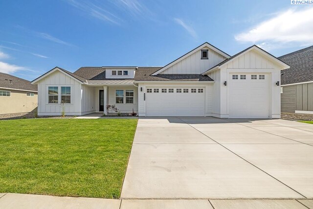 12110 Dunsmuir Dr, Pasco, WA 99301 - modern inspired farmhouse featuring board and batten siding, an attached garage, a front lawn, and driveway