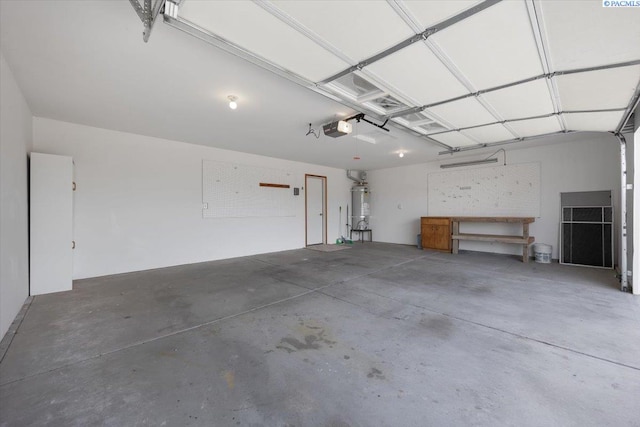 3438 S Buntin Ct, Kennewick, WA 99337 - garage featuring water heater, a garage door opener, and a workshop area