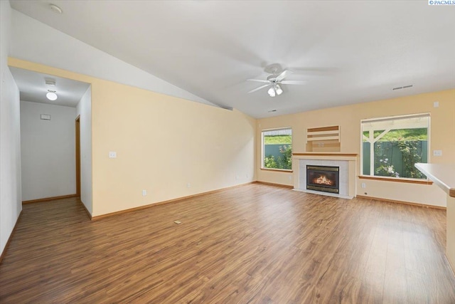 3438 S Buntin Ct, Kennewick, WA 99337 - unfurnished living room featuring ceiling fan, wood finished floors, a premium fireplace, lofted ceiling, and baseboards