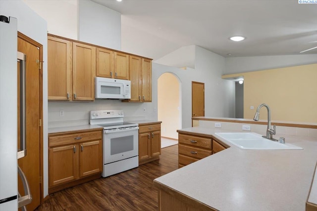 3438 S Buntin Ct, Kennewick, WA 99337 - kitchen featuring white appliances, a sink, dark wood finished floors, arched walkways, and light countertops