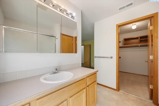 3438 S Buntin Ct, Kennewick, WA 99337 - bathroom featuring vanity, a walk in closet, and a shower with shower door