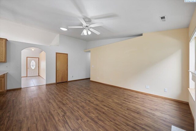 3438 S Buntin Ct, Kennewick, WA 99337 - unfurnished living room with lofted ceiling, ceiling fan, arched walkways, wood finished floors, and baseboards