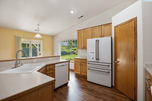 3438 S Buntin Ct, Kennewick, WA 99337 - kitchen featuring white appliances, a sink, vaulted ceiling, light countertops, and dark wood-style flooring