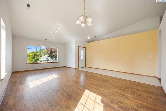 3438 S Buntin Ct, Kennewick, WA 99337 - unfurnished room with a chandelier, hardwood / wood-style flooring, lofted ceiling, rail lighting, and baseboards