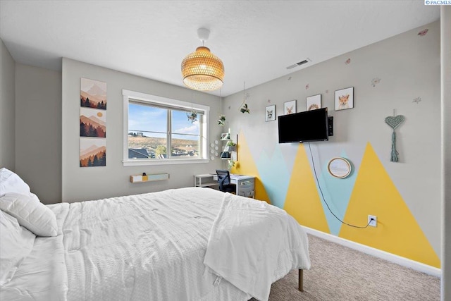 carpeted bedroom with visible vents and baseboards