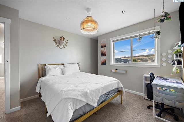 carpeted bedroom featuring baseboards